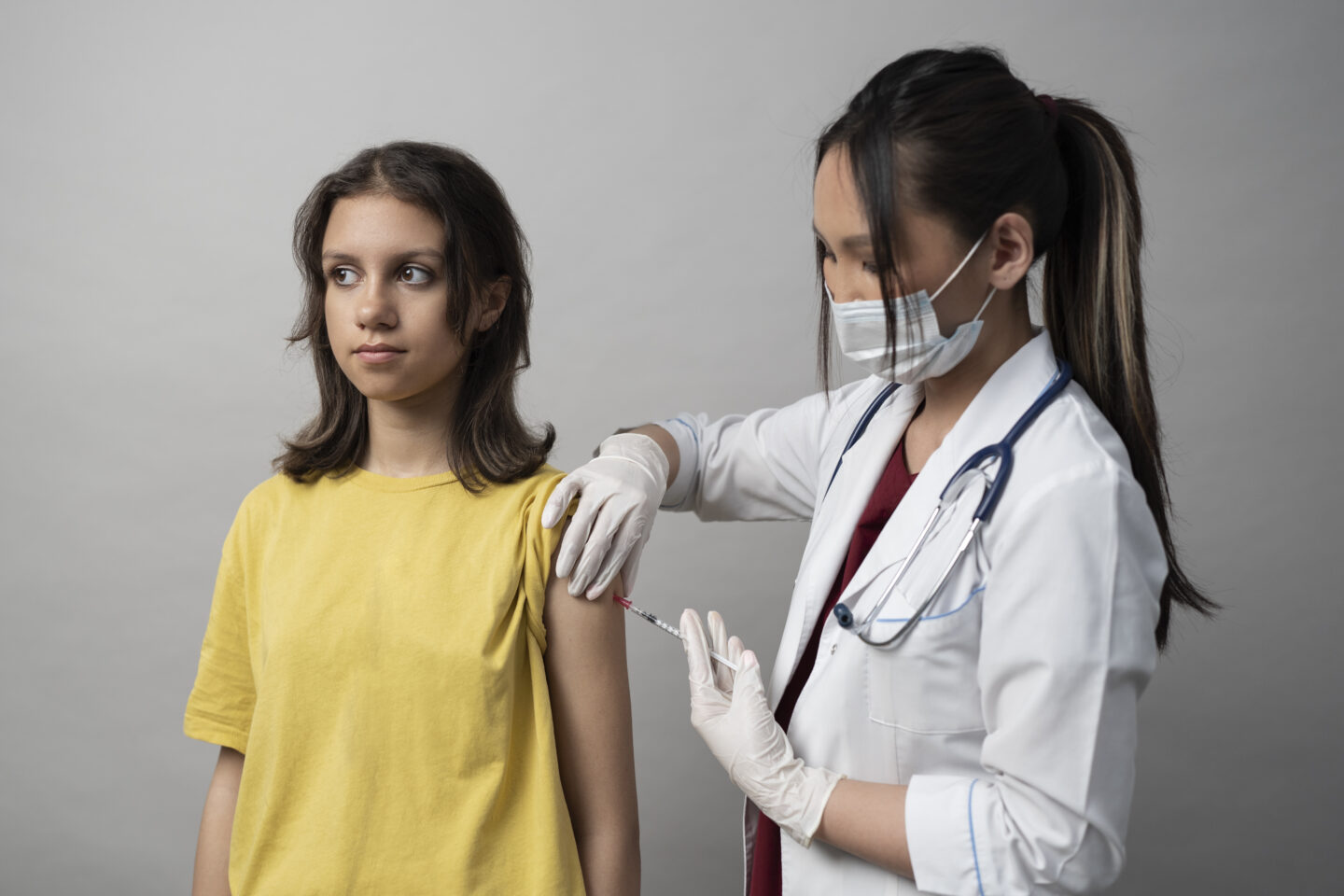 Teenager receiving a meningitis B (MenB) vaccination in the arm at a clinic in Preston.