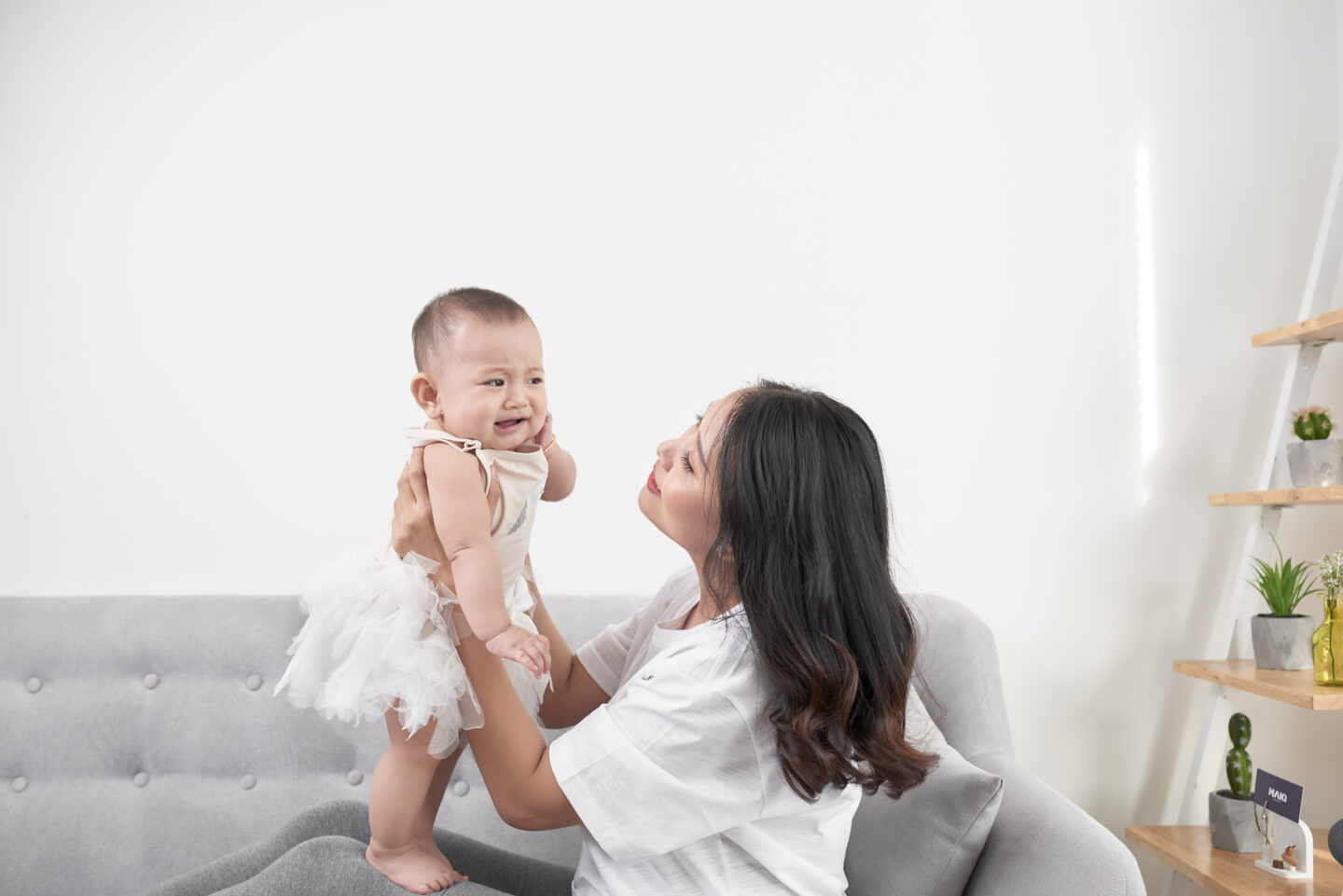 Mother and young child laughing together at home in a warm, healthy family moment