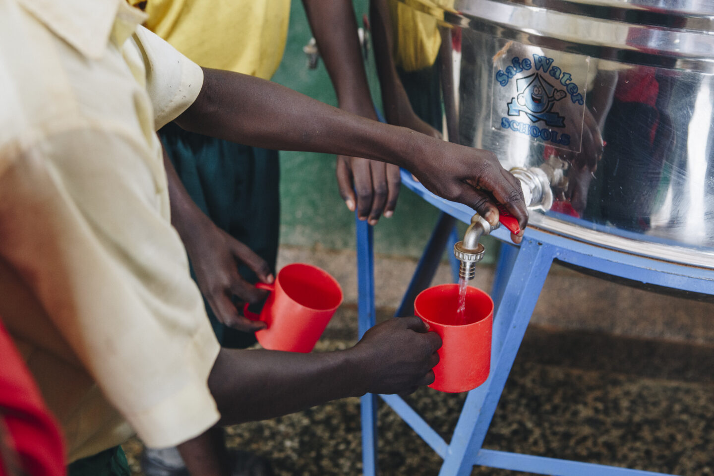 Community drinking water point in rural Uganda, illustrating why cholera vaccination is recommended for some travel