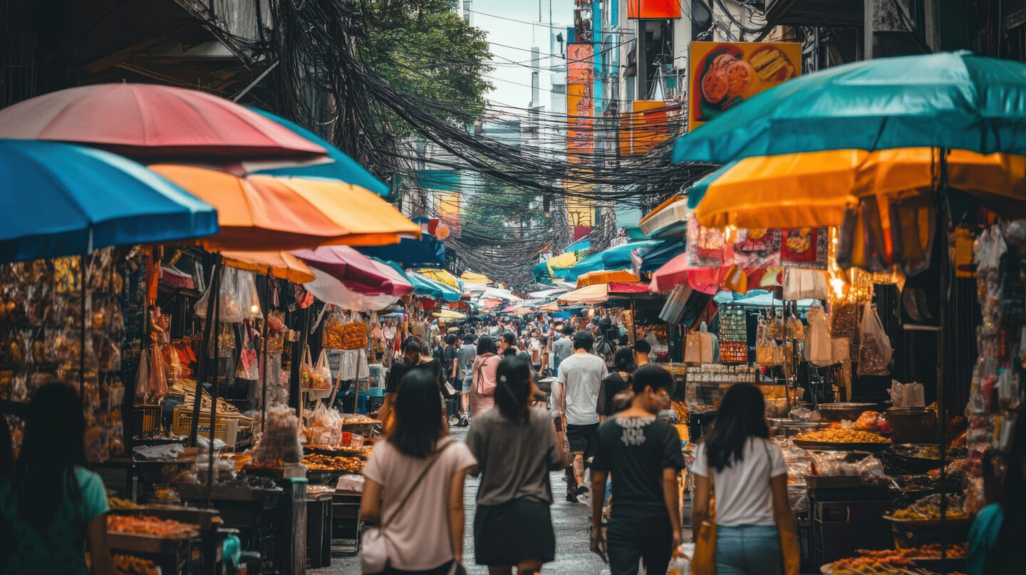 Colourful street food market stalls in Bangkok, a setting where hepatitis A vaccination is recommended for travellers
