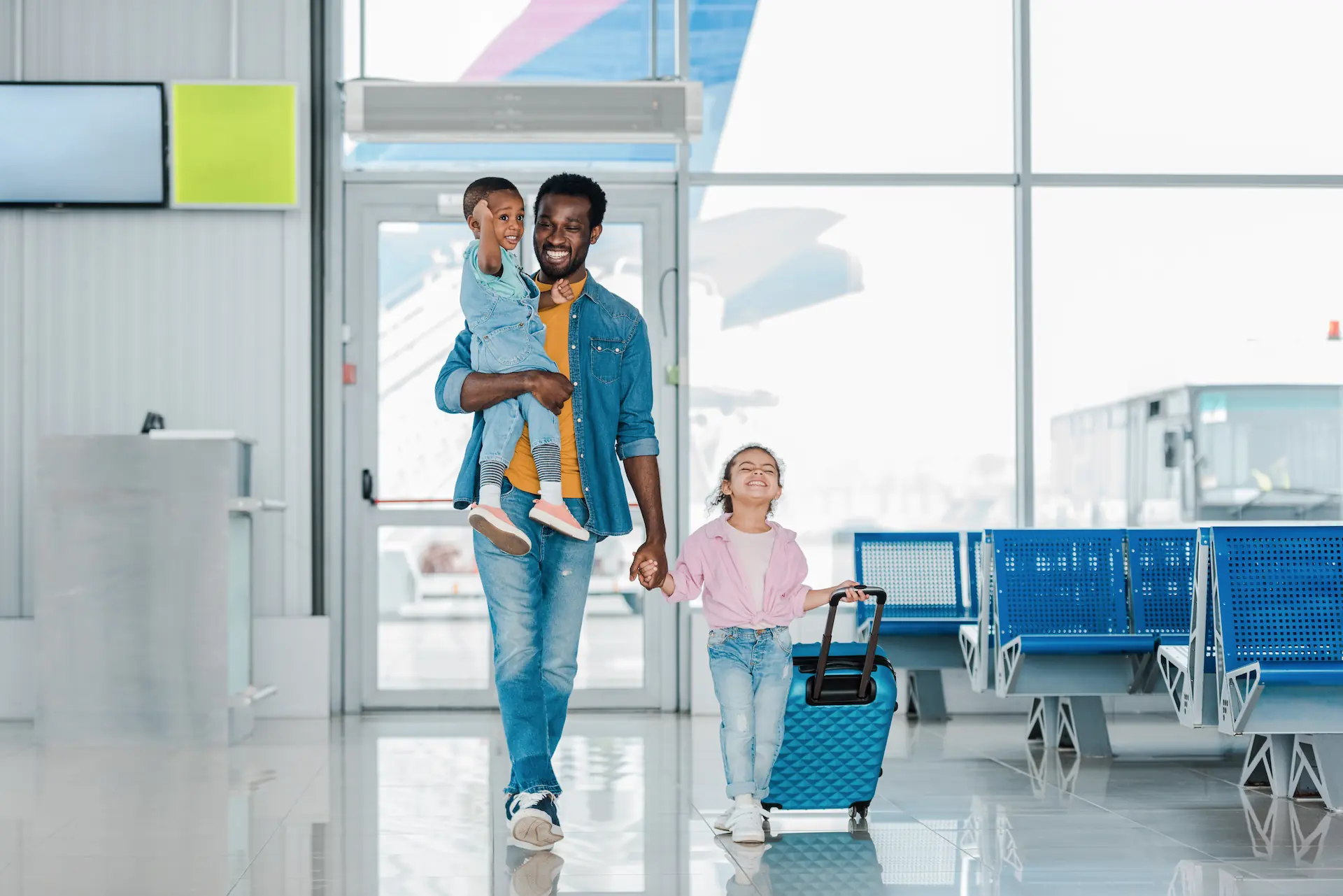 Family walking through an airport before a holiday