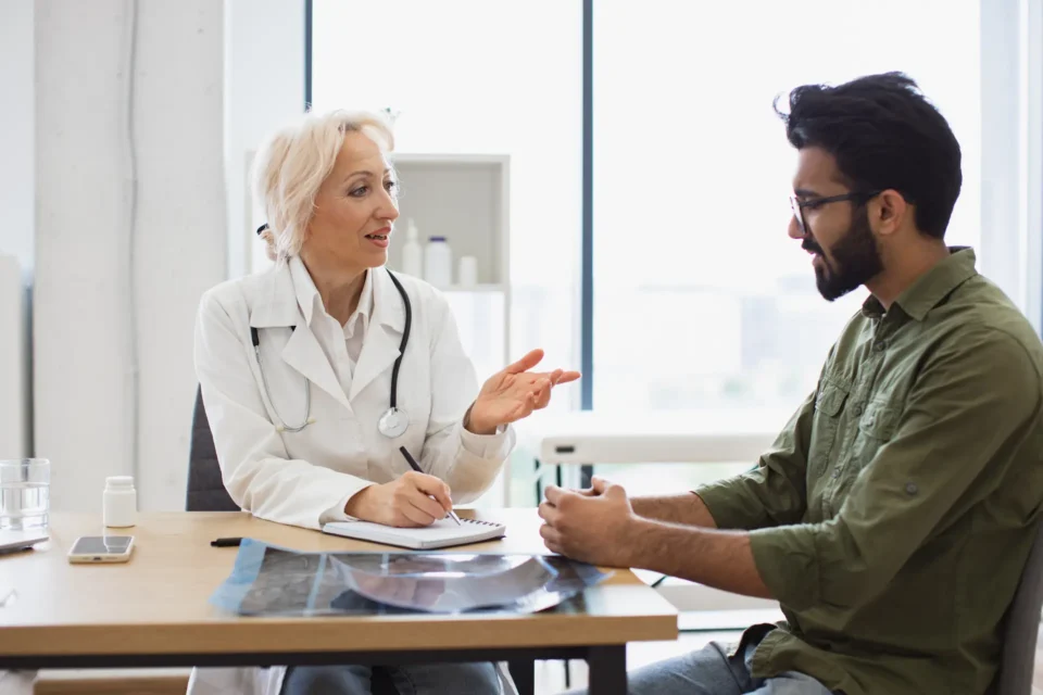 A pharmacist discussing treatment with a patient